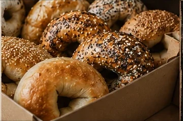 A box filled with assorted fresh bagels